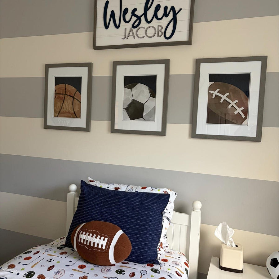 Customer photo of Design South basketball, soccer ball, and football prints in a striped sports-themed boy's bedroom.