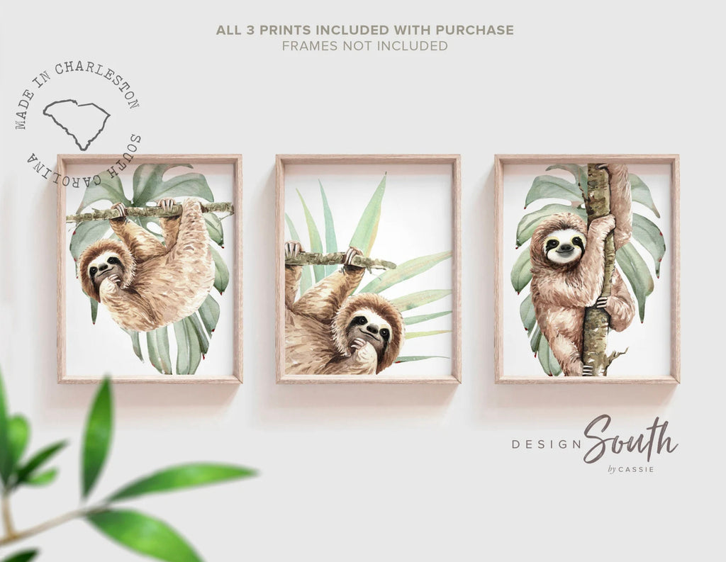 Hanging sloth wall art set featuring charming sloths in a relaxed, tropical rainforest theme. Perfect for a sloth-themed baby nursery, this artwork brings a playful, cozy vibe to any room. Neutral green and gray tones make it versatile for boys’ or girls’ rooms. This set is ideal for adding a whimsical touch to modern nursery decor, creating a peaceful atmosphere that babies and parents will love. Great baby shower gift for jungle-themed nurseries.