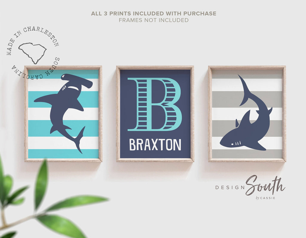 Blue gray shark-themed wall art for a toddler&#39;s room or kids&#39; bedroom. Features a friendly shark design perfect for shark-loving boys. Ideal for a personalized kids&#39; decor, this print includes a monogram or name customization option. Adds a playful, aquatic touch to any boy&#39;s room or nursery and makes a thoughtful gift for a baby shower or birthday. Modern, ocean-inspired design fits any shark theme room and complements existing sea life or ocean art decor.