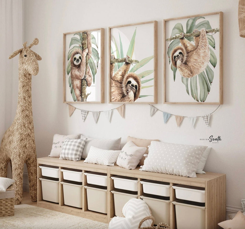 Hanging sloth wall art set featuring charming sloths in a relaxed, tropical rainforest theme. Perfect for a sloth-themed baby nursery, this artwork brings a playful, cozy vibe to any room. Neutral green and gray tones make it versatile for boys’ or girls’ rooms. This set is ideal for adding a whimsical touch to modern nursery decor, creating a peaceful atmosphere that babies and parents will love. Great baby shower gift for jungle-themed nurseries.