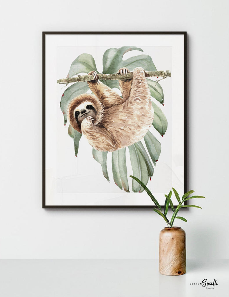 Hanging sloth wall art set featuring charming sloths in a relaxed, tropical rainforest theme. Perfect for a sloth-themed baby nursery, this artwork brings a playful, cozy vibe to any room. Neutral green and gray tones make it versatile for boys’ or girls’ rooms. This set is ideal for adding a whimsical touch to modern nursery decor, creating a peaceful atmosphere that babies and parents will love. Great baby shower gift for jungle-themed nurseries.