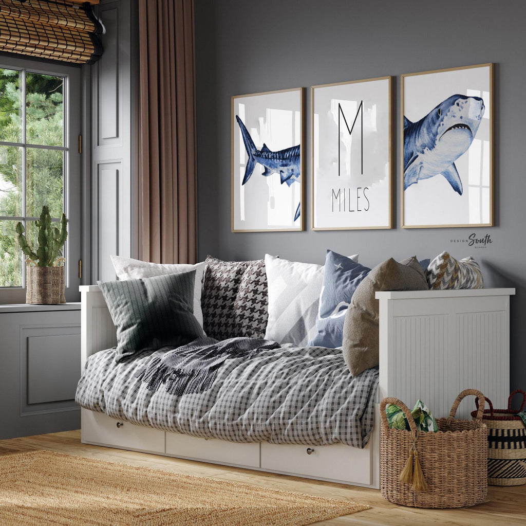 Set of shark-themed nursery wall art prints featuring a personalized boys name. Perfect for a baby boy’s room or ocean-themed nursery, this playful and modern artwork adds a fun touch to boys&#39; bedrooms or toddler spaces. Includes watercolor-style shark illustrations and bold text, ideal for a shark lover’s room or under-the-sea decor. A great gift for baby showers, birthdays, or parents creating a shark or marine life theme for their little one.