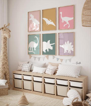 Adorable dinosaur art prints designed for a little girls room, featuring playful dinosaurs in shades of pink, teal, and purple. These vibrant and fun dinosaur illustrations are perfect for adding a touch of adventure and charm to toddler wall decor. Ideal for a girl&#39;s nursery, bedroom, or playroom, these art prints create a whimsical and colorful space. Perfect for girls who love dinosaurs, this wall decor adds personality and joy to any room setting, making it a delightful addition to her s