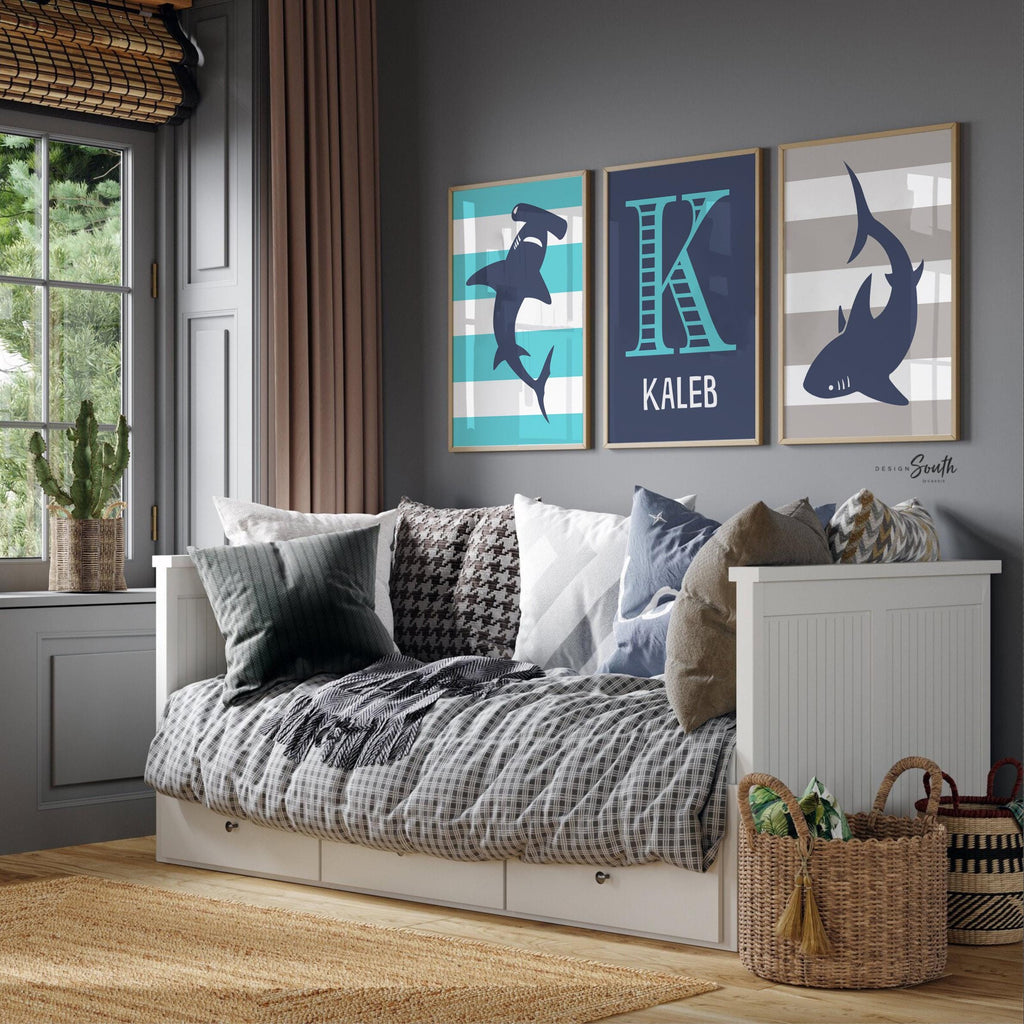 Blue gray shark-themed wall art for a toddler&#39;s room or kids&#39; bedroom. Features a friendly shark design perfect for shark-loving boys. Ideal for a personalized kids&#39; decor, this print includes a monogram or name customization option. Adds a playful, aquatic touch to any boy&#39;s room or nursery and makes a thoughtful gift for a baby shower or birthday. Modern, ocean-inspired design fits any shark theme room and complements existing sea life or ocean art decor.