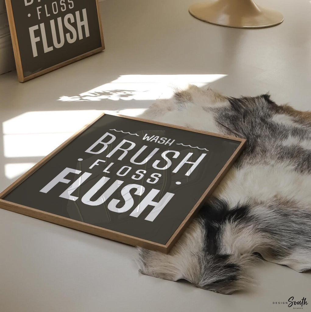 Brown and white bathroom wall art featuring the phrases &quot;wash, brush, floss, flush.&quot; Perfect for a boy’s bathroom or a gender-neutral space, this print brings a simple yet charming touch to any kids’ or guest bathroom. Great for encouraging healthy habits, this design blends well with brown and white decor themes, creating a clean, stylish look that suits both boys’ and girls’ bathrooms.