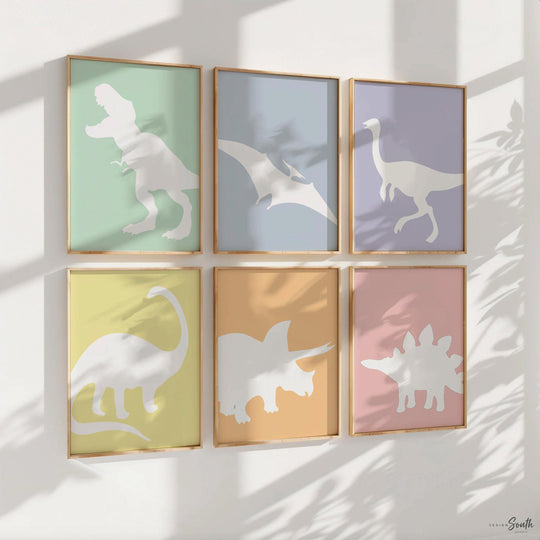 Adorable dinosaur art prints designed for a little girl's room, featuring playful dinosaurs in shades of pink, teal, and purple. These vibrant and fun dinosaur illustrations are perfect for adding a touch of adventure and charm to toddler wall decor. Ideal for a girl's nursery, bedroom, or playroom, these art prints create a whimsical colorful space. Perfect for girls who love dinosaurs, this wall decor adds personality and joy to any room setting, making it a delightful addition to her