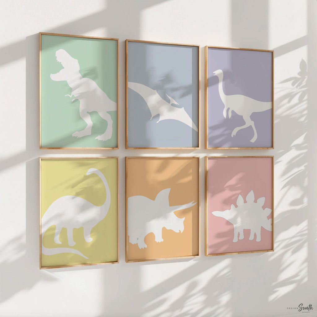 Adorable dinosaur art prints designed for a little girl&#39;s room, featuring playful dinosaurs in shades of pink, teal, and purple. These vibrant and fun dinosaur illustrations are perfect for adding a touch of adventure and charm to toddler wall decor. Ideal for a girl&#39;s nursery, bedroom, or playroom, these art prints create a whimsical colorful space. Perfect for girls who love dinosaurs, this wall decor adds personality and joy to any room setting, making it a delightful addition to her