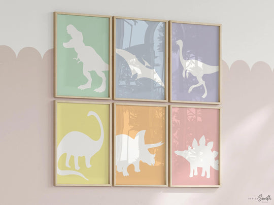 Adorable dinosaur art prints designed for a little girl's room, featuring playful dinosaurs in shades of pink, teal, and purple. These vibrant and fun dinosaur illustrations are perfect for adding a touch of adventure and charm to toddler wall decor. Ideal for a girl's nursery, bedroom, or playroom, these art prints create a whimsical colorful space. Perfect for girls who love dinosaurs, this wall decor adds personality and joy to any room setting, making it a delightful addition to her
