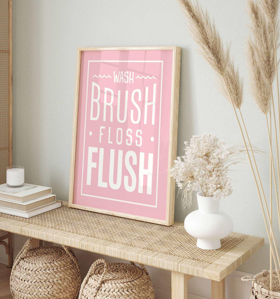 Pink bathroom wall art for girls featuring the phrases &quot;wash, brush, floss, flush&quot; in soft pink and white tones. Perfect for a girl&#39;s bathroom or powder room, this print adds a fun and feminine touch while encouraging daily hygiene routines. Ideal for children&#39;s bathroom decor, pink bathroom themes, or playful girly wall accents.