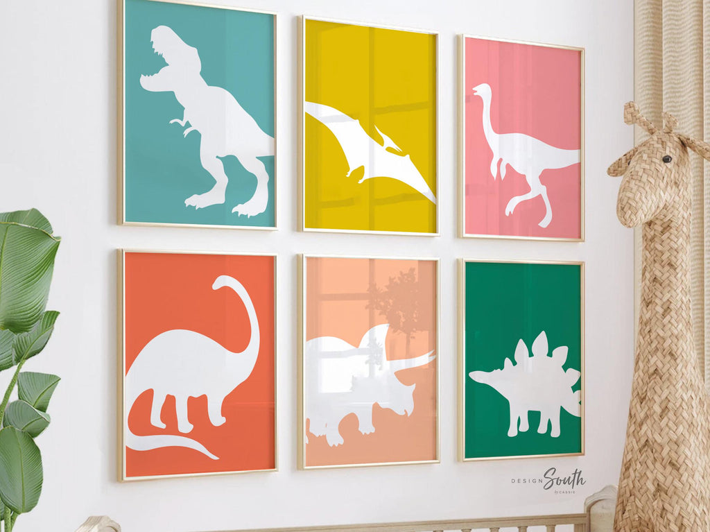 Dinosaur posters for kids and toddlers featuring a playful, retro-themed design. This wall art set includes different types of dinosaurs, perfect for a children&#39;s bedroom, playroom, or nursery. Vibrant colors and fun illustrations create an educational and decorative touch for any dinosaur-themed space. Ideal gift idea for dino-loving toddlers, helping spark their imagination and love for prehistoric creatures.