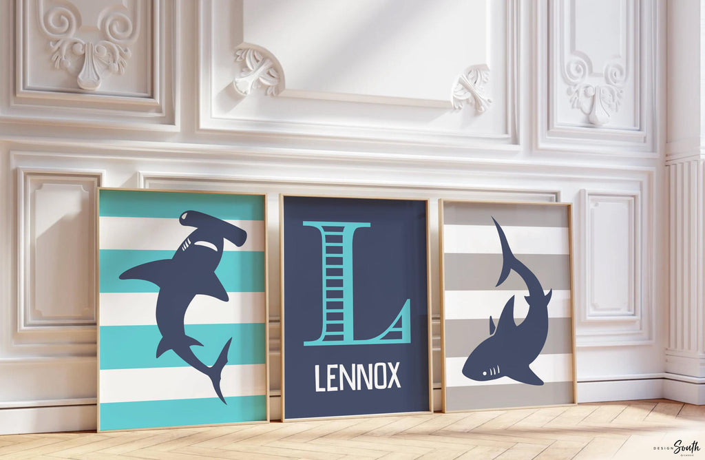 Blue gray shark-themed wall art for a toddler&#39;s room or kids&#39; bedroom. Features a friendly shark design perfect for shark-loving boys. Ideal for a personalized kids&#39; decor, this print includes a monogram or name customization option. Adds a playful, aquatic touch to any boy&#39;s room or nursery and makes a thoughtful gift for a baby shower or birthday. Modern, ocean-inspired design fits any shark theme room and complements existing sea life or ocean art decor.