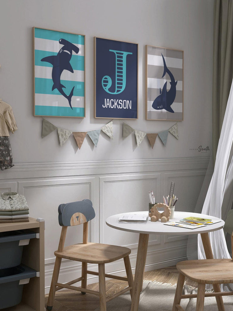 Blue gray shark-themed wall art for a toddler&#39;s room or kids&#39; bedroom. Features a friendly shark design perfect for shark-loving boys. Ideal for a personalized kids&#39; decor, this print includes a monogram or name customization option. Adds a playful, aquatic touch to any boy&#39;s room or nursery and makes a thoughtful gift for a baby shower or birthday. Modern, ocean-inspired design fits any shark theme room and complements existing sea life or ocean art decor.