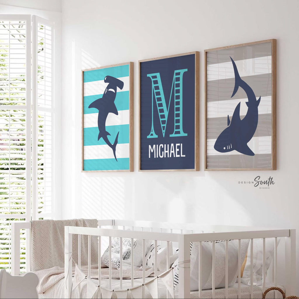 Blue gray shark-themed wall art for a toddler&#39;s room or kids&#39; bedroom. Features a friendly shark design perfect for shark-loving boys. Ideal for a personalized kids&#39; decor, this print includes a monogram or name customization option. Adds a playful, aquatic touch to any boy&#39;s room or nursery and makes a thoughtful gift for a baby shower or birthday. Modern, ocean-inspired design fits any shark theme room and complements existing sea life or ocean art decor.