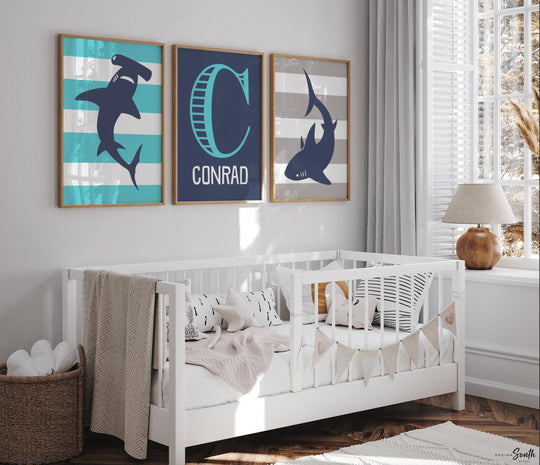 Blue gray shark-themed wall art for a toddler's room or kids' bedroom. Features a friendly shark design perfect for shark-loving boys. Ideal for a personalized kids' decor, this print includes a monogram or name customization option. Adds a playful, aquatic touch to any boy's room or nursery and makes a thoughtful gift for a baby shower or birthday. Modern, ocean-inspired design fits any shark theme room and complements existing sea life or ocean art decor.