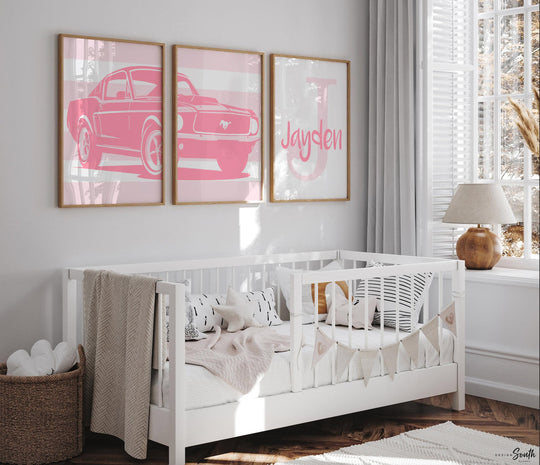 Pink Ford Mustang Shelby 1967 wall art print set designed for baby girls' nurseries or toddler rooms. This set of three prints features the classic muscle car in soft pink tones, adding a fun and stylish automotive touch to any girl's space. Perfect for a personalized nursery, toddler's bedroom, or as a unique baby shower gift. The pink hues bring a playful, feminine twist to the iconic car, creating a one-of-a-kind decor piece that sparks imagination and complements modern design.
