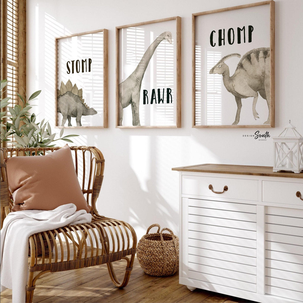 Watercolor dinosaur wall art set of 3 featuring a brachiosaurus, stegosaurus, and parasaurolophus in neutral earthy tones. Each print includes fun dinosaur-themed words: “Stomp,” “Roar,” and “Chomp,” making it perfect for a kids’ bedroom, playroom, or dinosaur-themed nursery. This playful and colorful artwork set adds a whimsical, prehistoric touch to any child’s space and makes a great gift for dino-loving toddlers or new parents decorating a gender-neutral nursery.