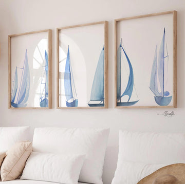 Set of 3 coastal sailboat art prints featuring watercolor paintings of sailboats on the ocean and lake. Nautical wall decor perfect for a beach house, lake house, coastal bathroom, or ocean-themed nursery. These prints showcase soft, serene colors with a calming seaside feel, ideal for summer home decor or a relaxing wall art set. Great gift for coastal lovers or sailing enthusiasts. Unframed prints available in multiple sizes for easy display and framing.