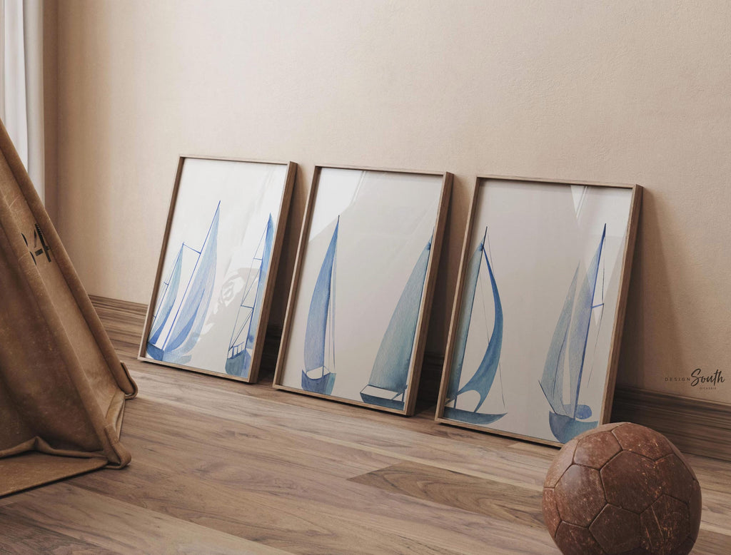 Set of 3 coastal sailboat art prints featuring watercolor paintings of sailboats on the ocean and lake. Nautical wall decor perfect for a beach house, lake house, coastal bathroom, or ocean-themed nursery. These prints showcase soft, serene colors with a calming seaside feel, ideal for summer home decor or a relaxing wall art set. Great gift for coastal lovers or sailing enthusiasts. Unframed prints available in multiple sizes for easy display and framing.