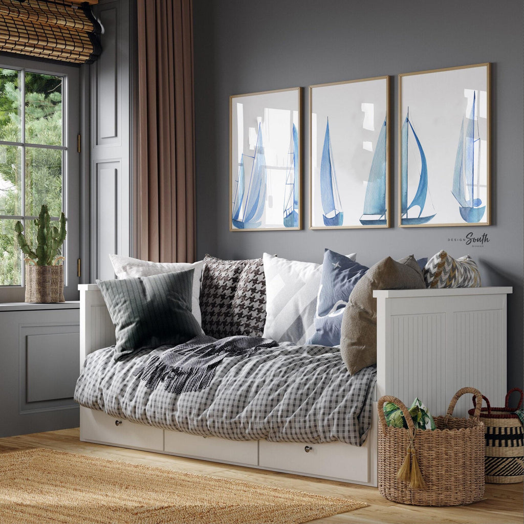 Set of 3 coastal sailboat art prints featuring watercolor paintings of sailboats on the ocean and lake. Nautical wall decor perfect for a beach house, lake house, coastal bathroom, or ocean-themed nursery. These prints showcase soft, serene colors with a calming seaside feel, ideal for summer home decor or a relaxing wall art set. Great gift for coastal lovers or sailing enthusiasts. Unframed prints available in multiple sizes for easy display and framing.