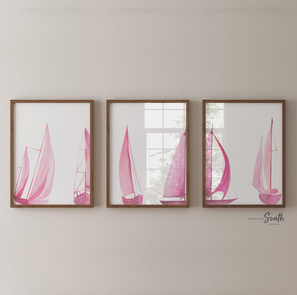 Set of 3 pink sailboat watercolor art prints featuring soft coastal scenes with ocean and lake views. These nautical wall decor pieces are perfect for a beach house, lake house, coastal bathroom, or a girl’s ocean-themed nursery. The soothing pastel tones and feminine sailing details create a light, breezy atmosphere. Ideal gift for those who love the coast, sailing, or soft pink decor. Unframed prints available in multiple sizes for versatile styling and easy framing.