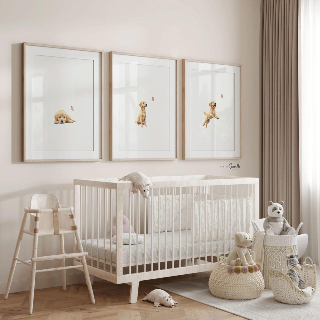 Set of 3 nursery art prints featuring golden retriever puppies playfully chasing pink butterflies. Designed in a soft, clean, and modern style, this sweet wall art set is perfect for a baby girl&#39;s nursery or toddler bedroom. The gentle color palette and simple composition create a calming and adorable atmosphere, ideal for dog lovers and parents looking to add a personalized, heartwarming touch to their child’s space.