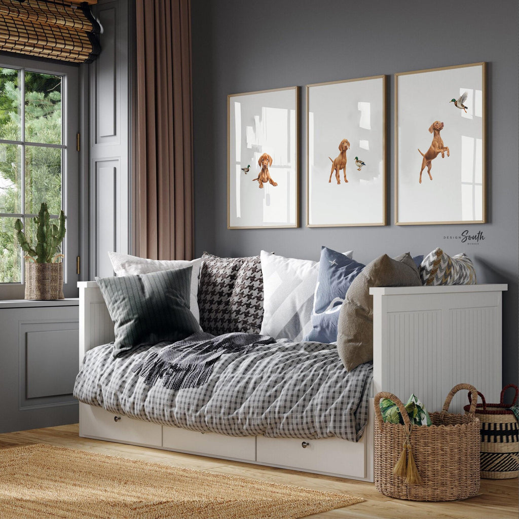 Set of 3 nursery art prints featuring Hungarian vizsla puppies accented with mallard duck birds. Designed in a soft, clean, and modern style, this sweet wall art set is perfect for a baby boy&#39;s nursery or toddler bedroom. The gentle color palette and simple composition create a calming and adorable atmosphere, ideal for dog lovers and parents looking to add a personalized, heartwarming touch to their child’s space.