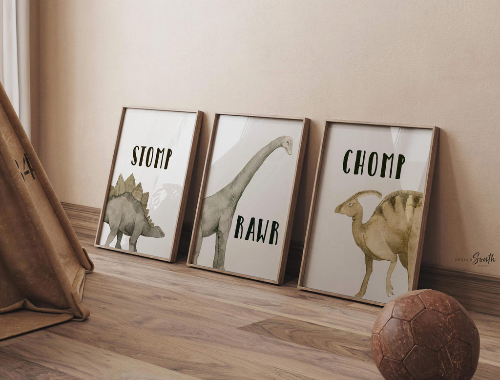Watercolor dinosaur wall art set of 3 featuring a brachiosaurus, stegosaurus, and parasaurolophus in neutral earthy tones. Each print includes fun dinosaur-themed words: “Stomp,” “Roar,” and “Chomp,” making it perfect for a kids’ bedroom, playroom, or dinosaur-themed nursery. This playful and colorful artwork set adds a whimsical, prehistoric touch to any child’s space and makes a great gift for dino-loving toddlers or new parents decorating a gender-neutral nursery.