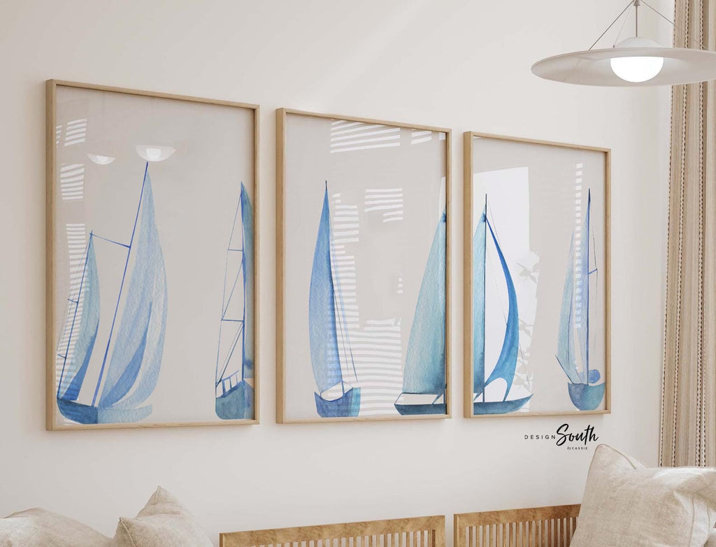 Set of 3 coastal sailboat art prints featuring watercolor paintings of sailboats on the ocean and lake. Nautical wall decor perfect for a beach house, lake house, coastal bathroom, or ocean-themed nursery. These prints showcase soft, serene colors with a calming seaside feel, ideal for summer home decor or a relaxing wall art set. Great gift for coastal lovers or sailing enthusiasts. Unframed prints available in multiple sizes for easy display and framing.
