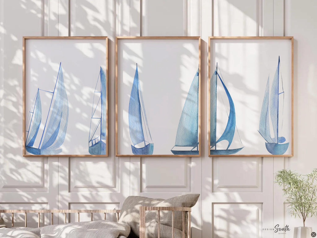 Set of 3 coastal sailboat art prints featuring watercolor paintings of sailboats on the ocean and lake. Nautical wall decor perfect for a beach house, lake house, coastal bathroom, or ocean-themed nursery. These prints showcase soft, serene colors with a calming seaside feel, ideal for summer home decor or a relaxing wall art set. Great gift for coastal lovers or sailing enthusiasts. Unframed prints available in multiple sizes for easy display and framing.