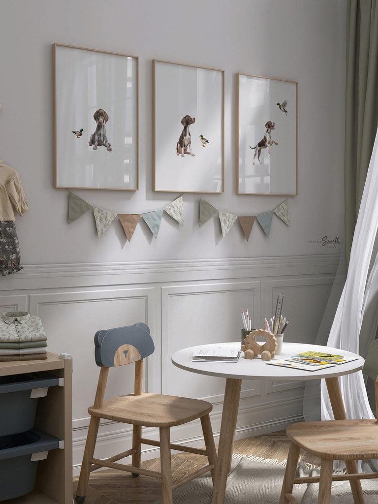 Set of 3 wall art prints featuring German Shorthaired Pointers (GSP) in a duck hunting scene, perfect for a toddler boy nursery or baby room. This series includes a pointing bird dog, a mallard duck taking flight, and a classic hunting dog stance. Designed for little boys who love the outdoors or come from hunting families, this bird dog artwork brings a rustic, adventurous feel to any space. Ideal for nurseries, playrooms, or as a unique gift for duck hunting enthusiasts.