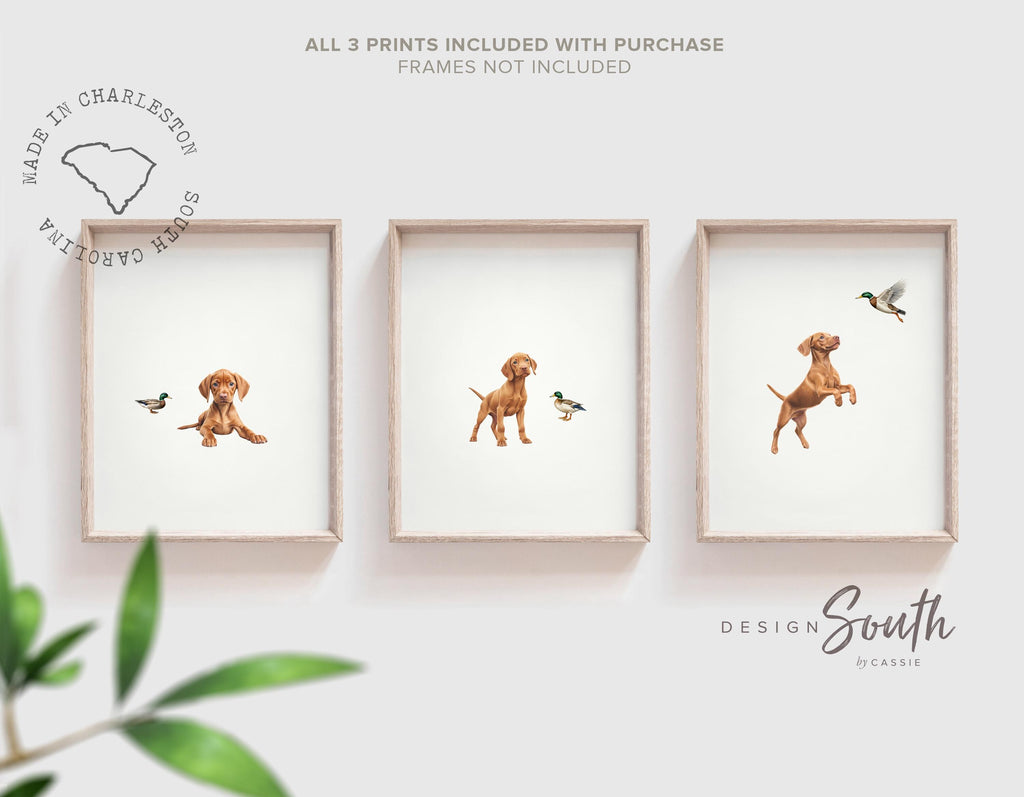 Set of 3 nursery art prints featuring Hungarian vizsla puppies accented with mallard duck birds. Designed in a soft, clean, and modern style, this sweet wall art set is perfect for a baby boy&#39;s nursery or toddler bedroom. The gentle color palette and simple composition create a calming and adorable atmosphere, ideal for dog lovers and parents looking to add a personalized, heartwarming touch to their child’s space.