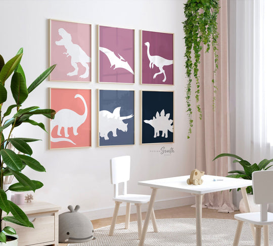 Adorable dinosaur art prints designed for a little girl's room, featuring playful dinosaurs in shades of pink, teal, and purple. These vibrant and fun dinosaur illustrations are perfect for adding a touch of adventure and charm to toddler wall decor. Ideal for a girl's nursery, bedroom, or playroom, these art prints create a whimsical and colorful space. Perfect for girls who love dinosaurs, this wall decor adds personality and joy to any room setting, making it a delightful addition to her space.